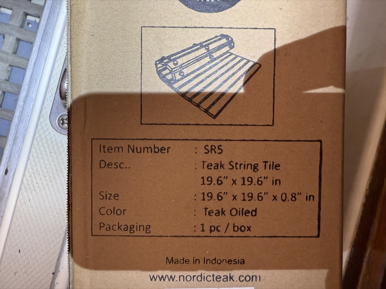 Nordic Teak SR5 Teak String Tile box showing 19.6 x 19.6 inch dimensions, teak oiled, made in Indonesia