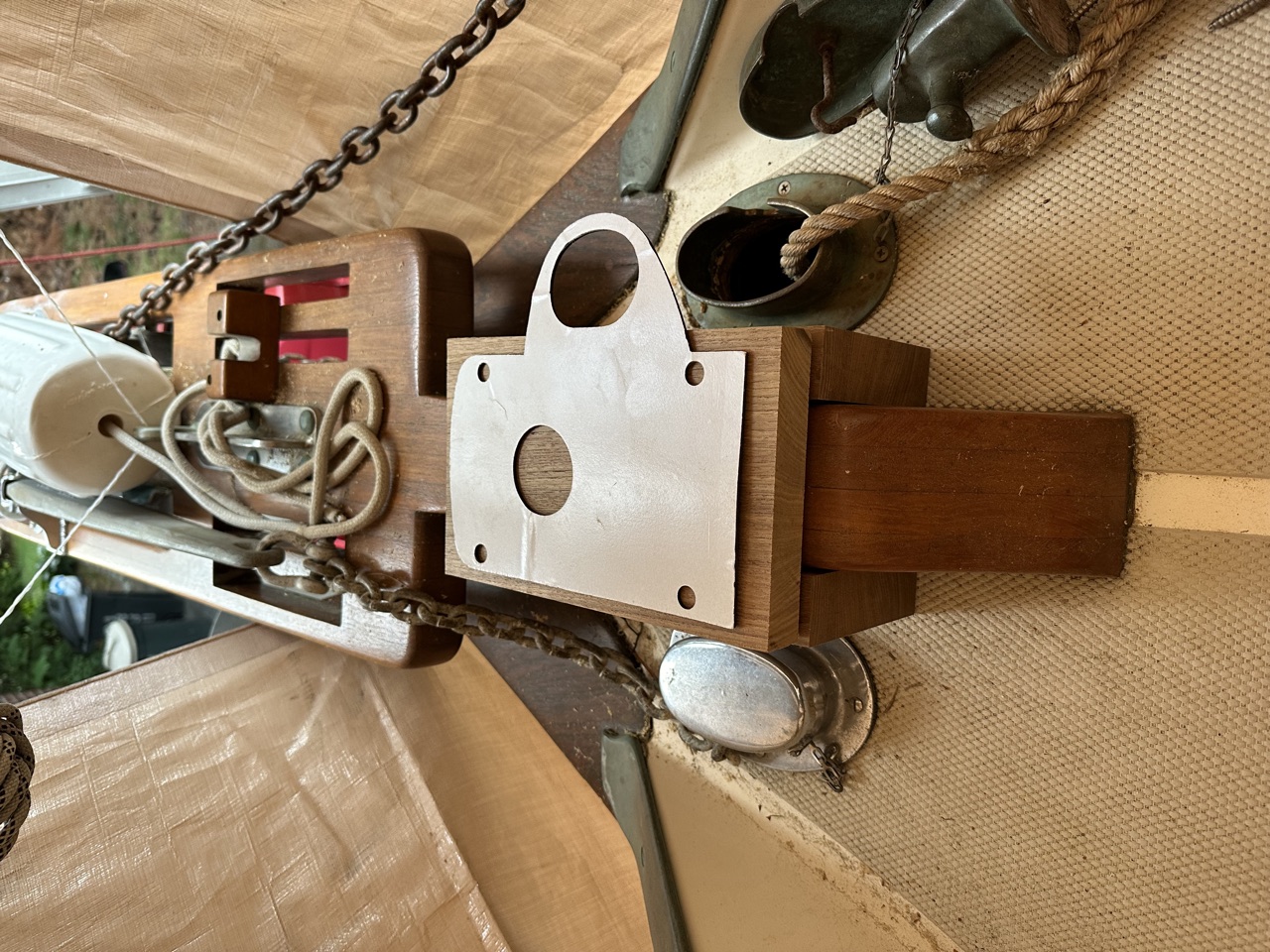 New teak support boards dry-fitted on the bowsprit with the windlass aluminum mounting plate positioned on top