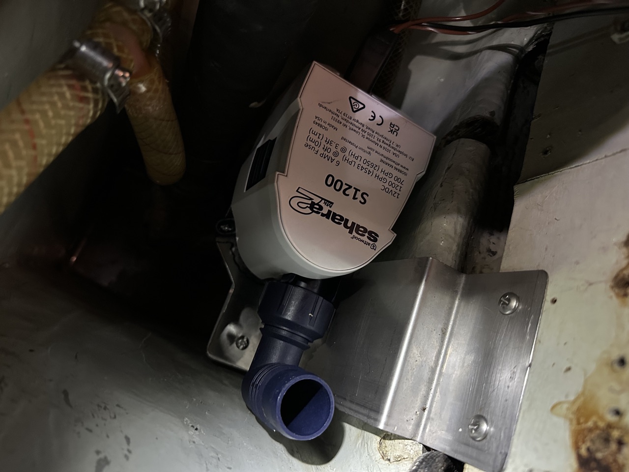 Attwood Sahara MK2 S1200 bilge pump mounted on a stainless bracket in the bilge of Queen of Hearts