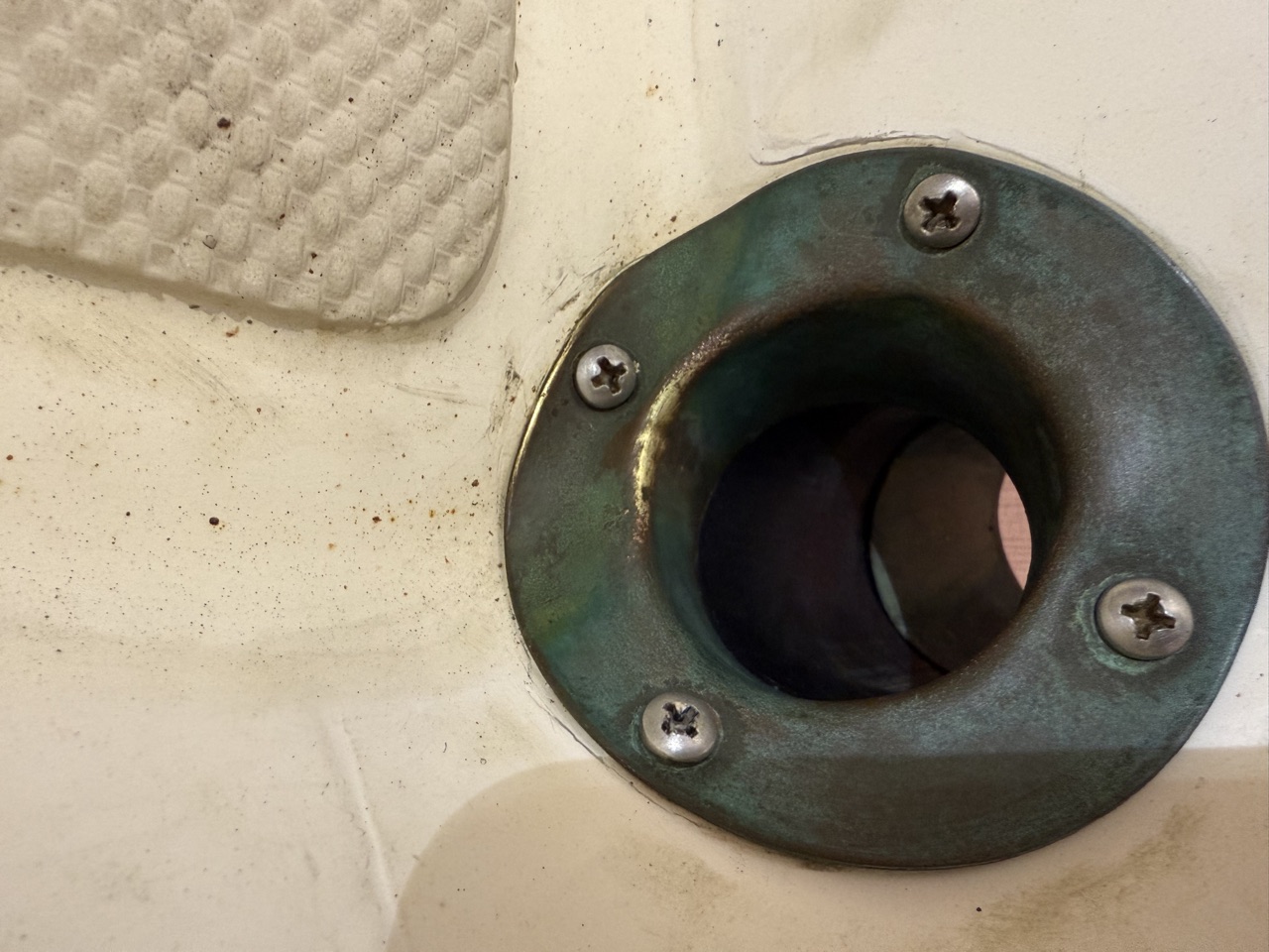 Finished foredeck scupper reinstalled with new 4200 sealant and stainless screws on Queen of Hearts