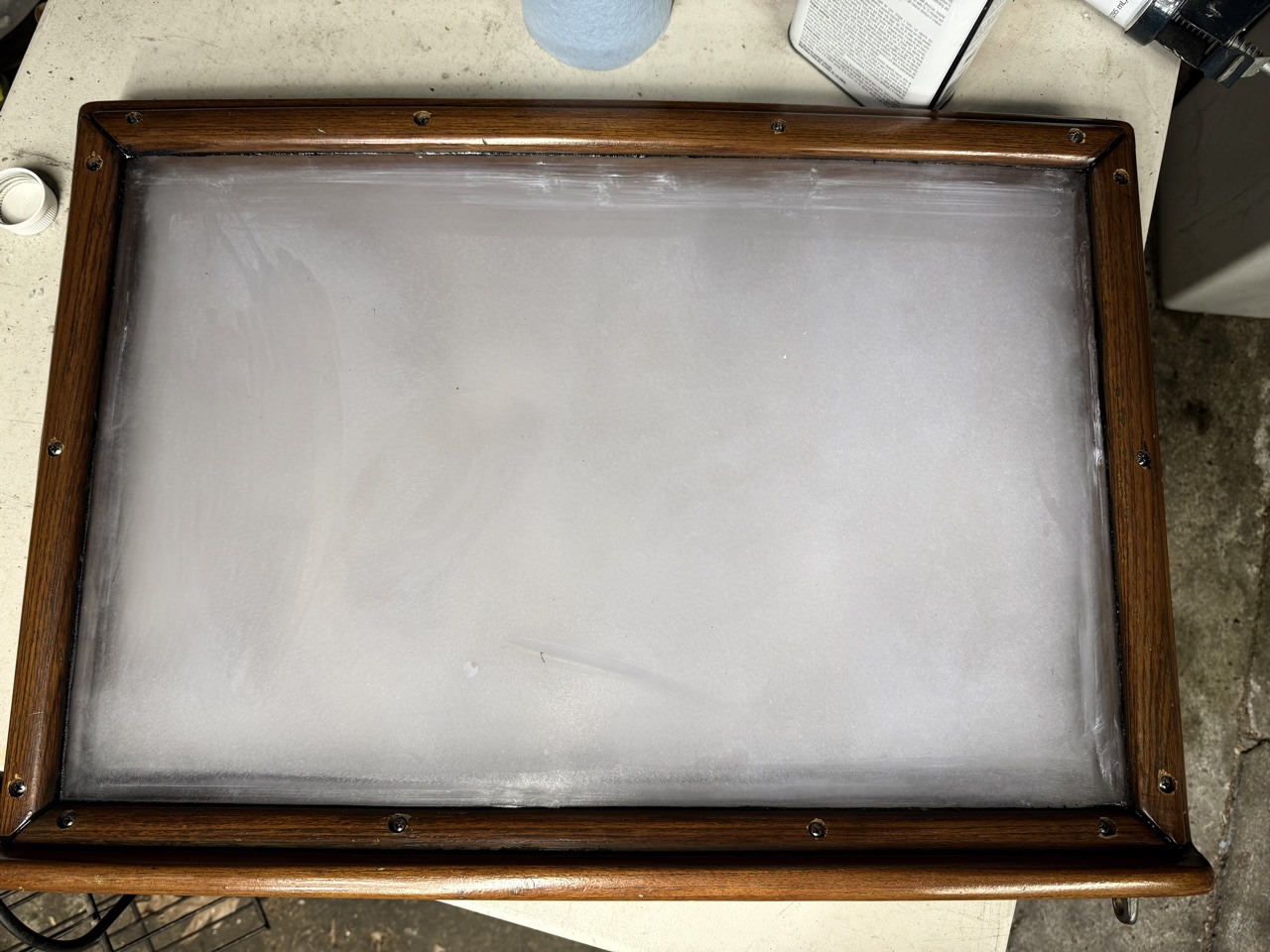 Finished aft cabin hatch with tape removed, showing the clean frosted polycarbonate panel in the teak frame