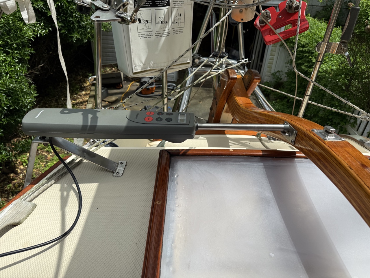 Rebuilt aft cabin sliding hatch installed on Queen of Hearts, showing the teak frame and frosted polycarbonate panel in place