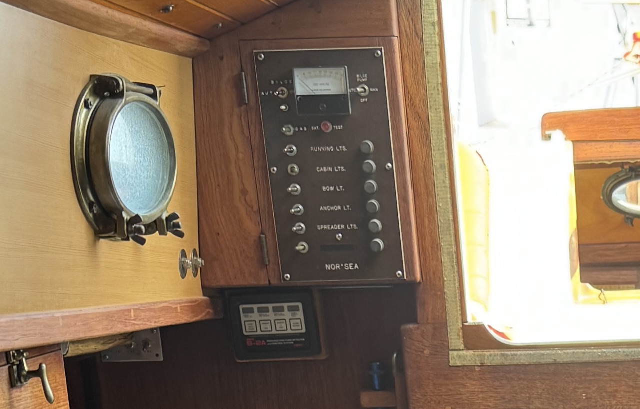 Original Nor'Sea fuse-based electrical panel with toggle switches for running lights, cabin lights, bow light, anchor light, and spreader lights