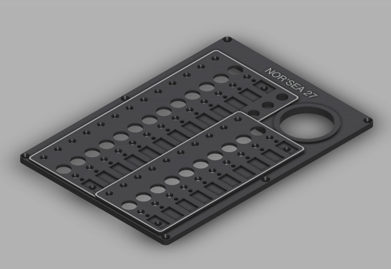 Isometric CAD render of the two-piece Nor'Sea 27 electrical panel design showing the breaker sections and round BMV-712 opening