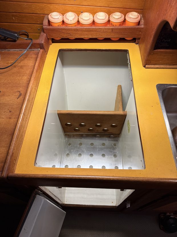 Original Nor'Sea 27 icebox open, showing aluminum liner and teak divider